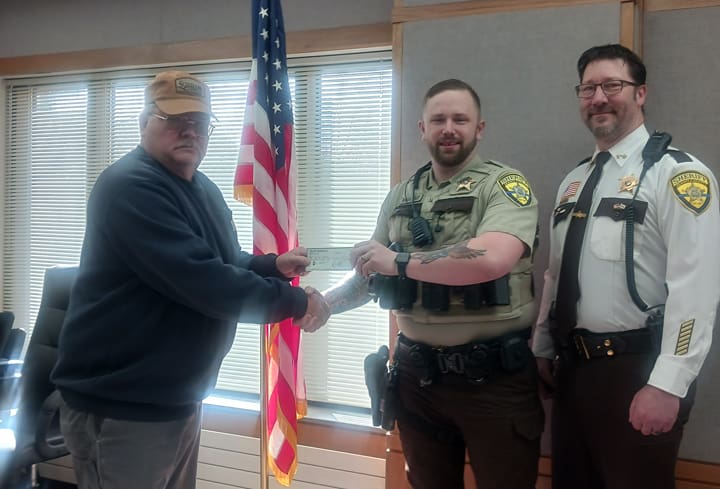 The Isanti County Sportsmen's Club gave a $5,000 donation to the Isanti County Sheriff’s department for their K9 program.